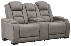 Reserved for him and made for her, this power reclining loveseat in gray delivers all the comfort and style you could ask for. Inspired by sports car interiors, the expertly matched leather and faux leather upholstery has a â€œperforated automotiveâ€ tre
