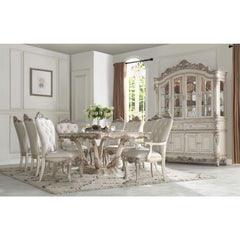 Exclusively designed and filled with romantic spirit, this beautiful rectangular table features a pedestal base with Queen Anne legs and carved apron and trim, decorated with raised and scrolled floral motifs in an antique champagne finish. This stylish a