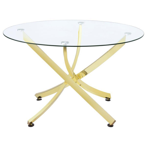 This round dining table offers a striking balance of clarity and form. A clear tempered glass top creates an airy presence, while the sculptural asterisk-style base adds dramatic visual interest. Crafted from heavy gauge metal, the base is electroplated i