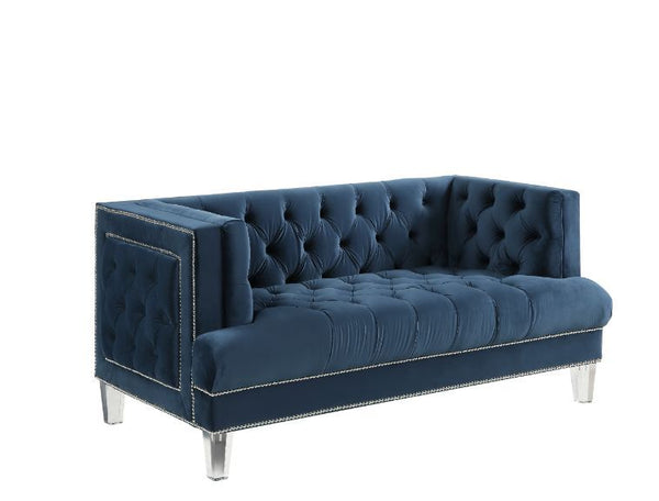 Sophistication meets modern with the Ansario living room collection. The rich blue velvet adds character to any room. Showcasing a square back, high arms, and nail-head trim, feature button tufted accents. The acrylic legs give off a modern vibe to the pi