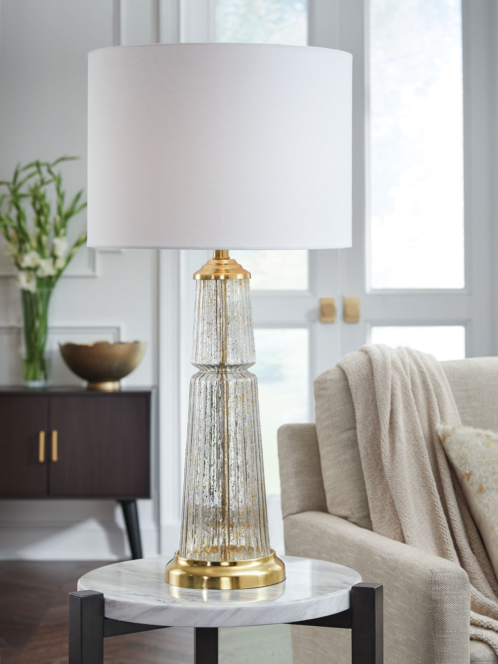 The lighter side of traditional style. We love how the sheer simplicity of this lamp-'s clear fluted glass infused with subtle goldtone flecks creates a beautiful blend of timeless design. An instant classic, it-'s perfect for a cozy reading nook or a sty