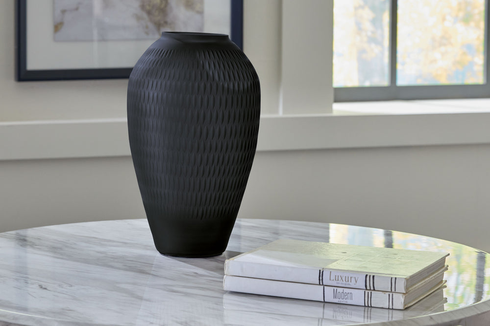 Let your eyes trace the alluring pattern running along this cut-glass vase. Its cylindrical silhouette is topped in contemporary splendor with a slate finish. Youâ€™ll surely enjoy the understated style and ever-present interest it brings to your decor.<b