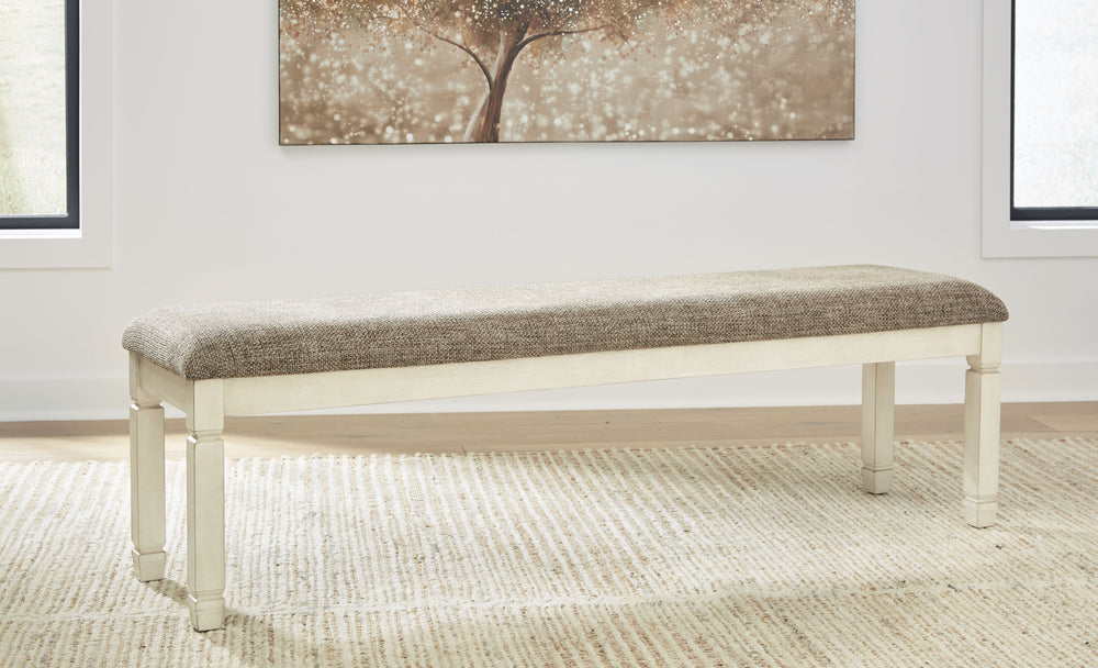 The beauty of this upholstered dining bench is something to savor. Serving up country cottage comfort and fresh farmhouse flair, the generously-scaled bench entices with a cushioned seat covered in a heavy woven fabric that complements the trendy textured