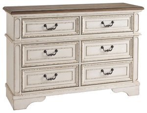 Elevating the art of traditional cottage styling, this dresser is your dream bedroom retreat realized. Its antiqued two-tone aesthetic blends a chipped white with a distressed wood finished top for added charm. Framed drawer fronts and decorative corbels 