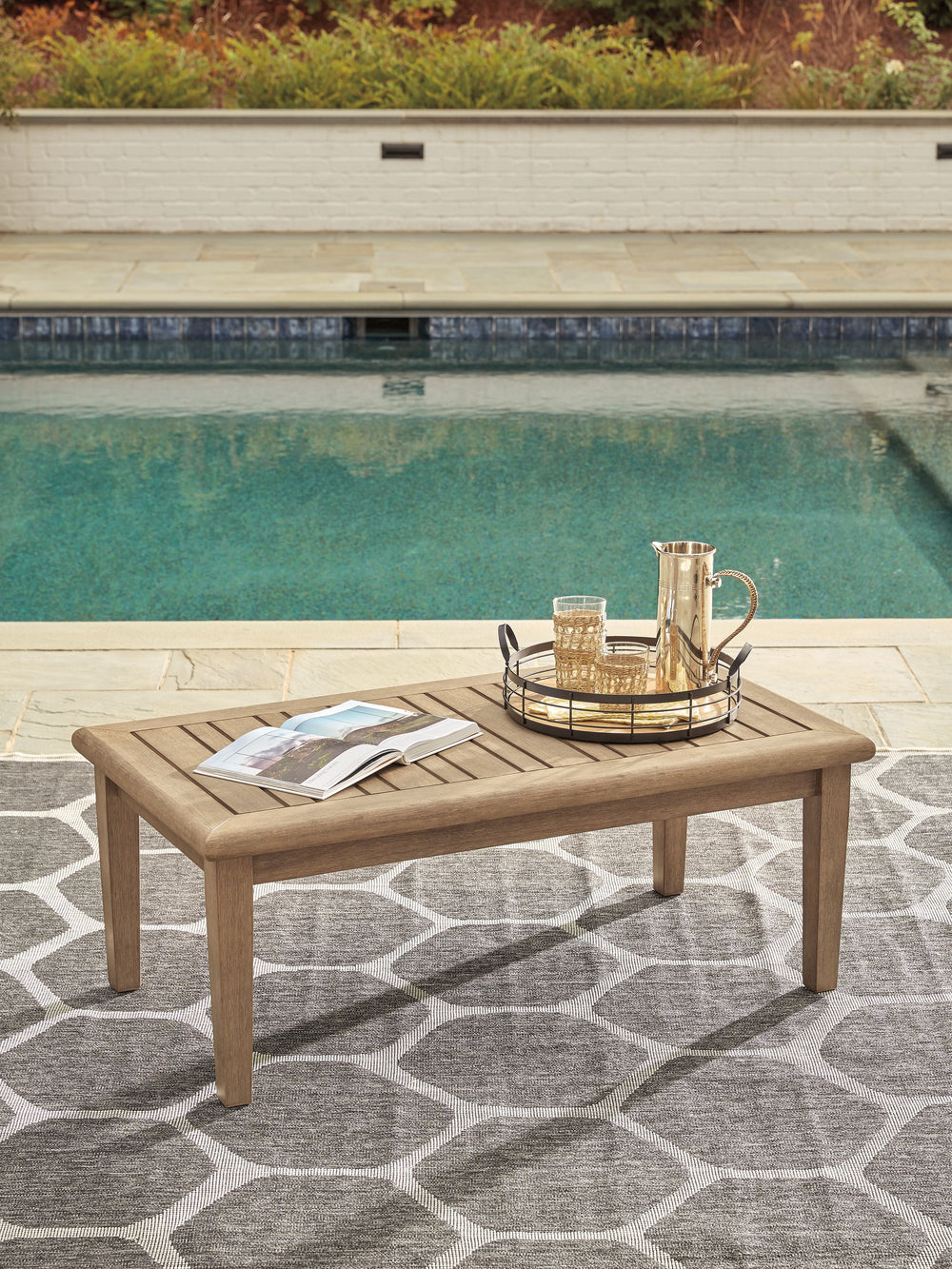 This outdoor coffee table effortlessly pairs natural beauty with must-have durability. Its eucalyptus wood construction withstands the elements while making a high-style impression. The perfect companion for relaxing on the porch or poolside, this table i