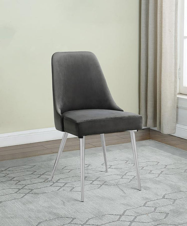  making it a perfect addition to any dining space. Upholstered in soft grey velvet