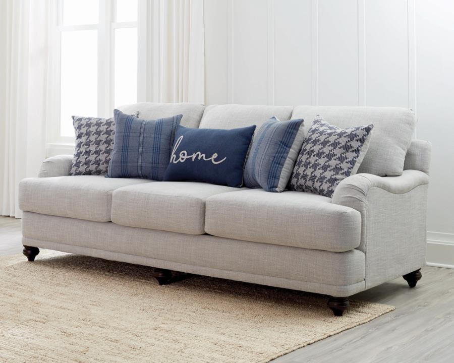 Farmhouse inspiration delivers a fresh, stylish look to a transitional space with this exceptional sofa. With tailored English arms and turned legs offering a contrasting espresso finish, this sofa shines with a light grey linen-like upholstered cover. Th