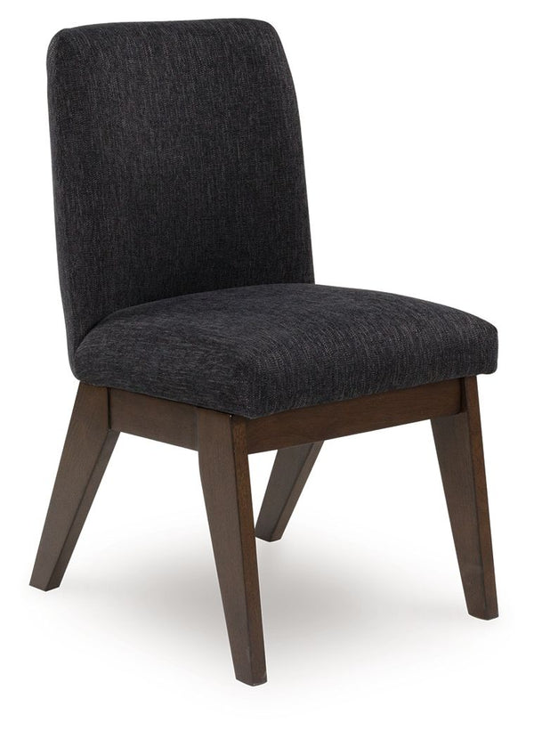 Casual contemporary styling with a decidedly modern vibe. Sitting atop a mid-century inspired base, this upholstered bucket dining chair has a rich warm brown finish that beckons everyone to gather around. Black textured upholstery dresses the chair in on