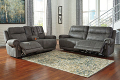 Take a rest with this living room set. Subtle touches such as sporty jumbo stitching, nailhead trim and a -"weather worn-" effect on the upholstery give this handsome set a buttoned-up appeal and fresh feel. Loveseat has center console with dual cup holde