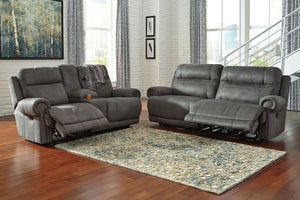 Take a rest with this living room set. Subtle touches such as sporty jumbo stitching, nailhead trim and a -"weather worn-" effect on the upholstery give this handsome set a buttoned-up appeal and fresh feel. Loveseat has center console with dual cup holde