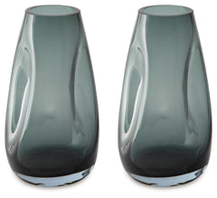Sleek. Contemporary. Chic. This vase has an organic sense of movement, recalling seaside aesthetics with its teal glass. A stunning solo accent, it also acts as a beautiful vessel for florals and other decorative fillers. And the vase is safe for outdoor 