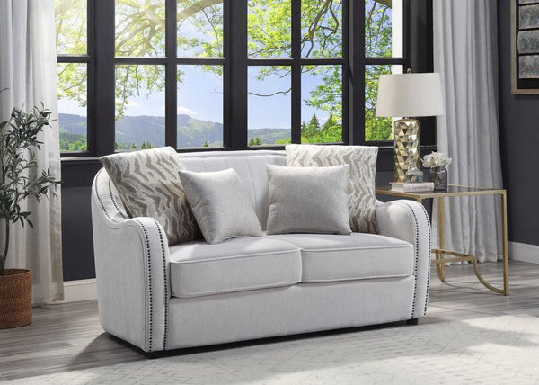 Create a clean, contemporary look with the gently curved Mahler living room set. The inner wooden frame and block plastic legs offer maximum support. Upholstered in a beige textured linen fabric and outlined with nailhead trim. The barrel seat and sloping