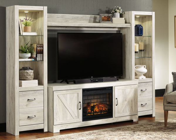 Express your farmhouse style with this entertainment center. Its wispy white finish over replicated oak wood grain is a delightful change from the ordinary. Clean-lined, classic styling with barn door inspiration provides a country chic aesthetic thatâ€™s