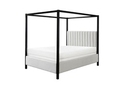 This canopy bed is a modern statement piece, blending the luxurious feel of a traditional four-poster bed with the clean, sleek lines of contemporary design. Its bold, black frame creates a striking silhouette against any bedroom backdrop, while the plush
