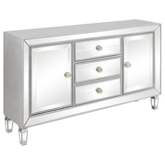 Make a glamorous statement with this champagne-finished accent cabinet, featuring dazzling mirrored panels and elegant beaded trim. Designed with three center drawers and two side doors, it offers ample concealed storage without sacrificing style. Tapered