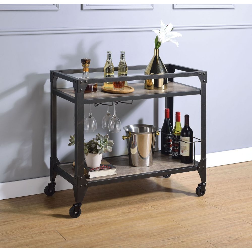 Round out your entertaining space in versatile style with this Jorgensen serving cart. Showcasing an industrial design, it features a metal frame in a matte black finish, two shelves wrapped in wooden veneer, and plank-inspired canvas prints. This versati