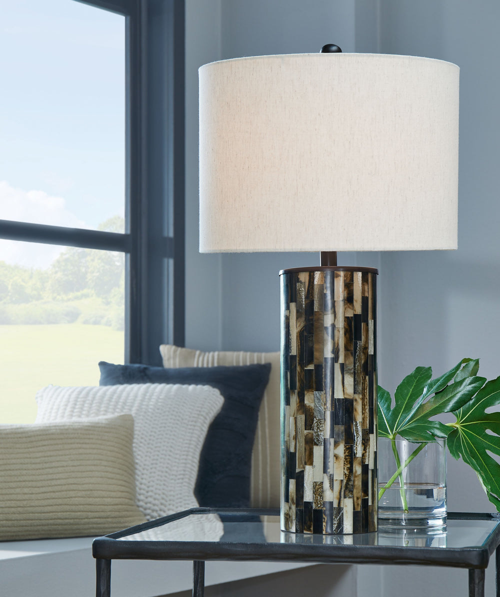 The mosaic patterned Ellford table lamp is a masterful interpretation of neutral hues. It prioritizes unique personality without sacrificing function. A decidedly contemporary addition to your decor, this eye-catching lamp sets the style tone for your hom
