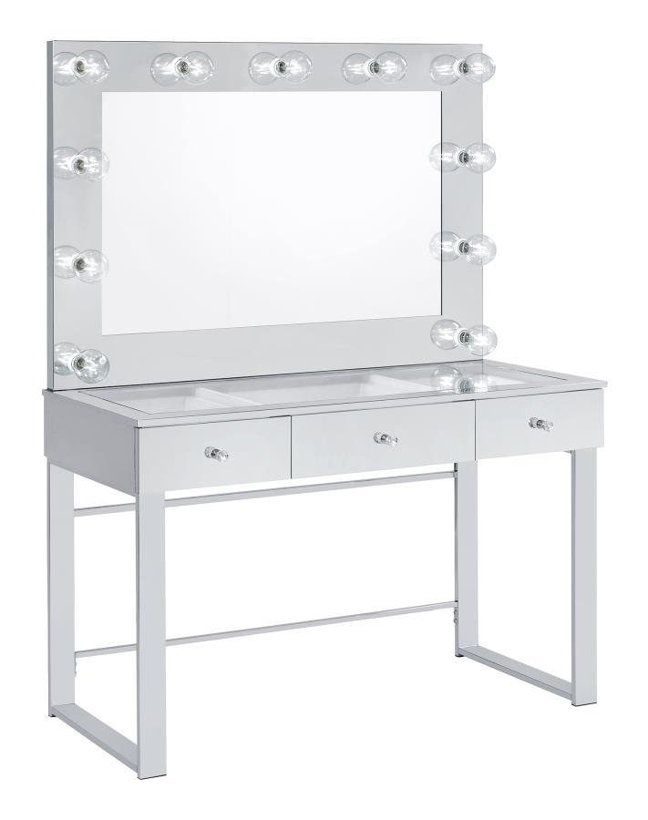 With a Hollywood regency flair, this modern vanity set features a stunning mirror paneled design that reflects surrounding hues. Cleverly designed with a clear tempered glass top that showcases cosmetics and accessories tucked inside the three drawers ben