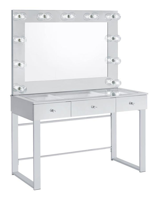 With a Hollywood regency flair, this modern vanity set features a stunning mirror paneled design that reflects surrounding hues. Cleverly designed with a clear tempered glass top that showcases cosmetics and accessories tucked inside the three drawers ben