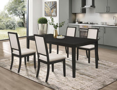 This five-piece dining set looks stunning with a variety of decor motifs. Crafted of solid hardwood and veneer, the elongated table and four side chairs boast an eye-catching distressed black finish. In a contrasting hue, the upholstered seat and back cus