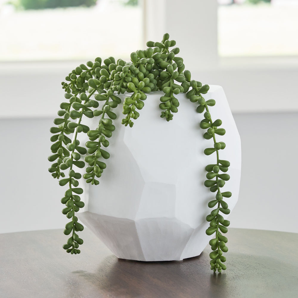 Equal parts elegant and organic, this vase brings ethereal beauty to your tabletop. Its white finish seamlessly harmonizes with existing accents. Meticulous craftsmanship creates the unique, faceted look of the hand-carved surface and makes each piece one