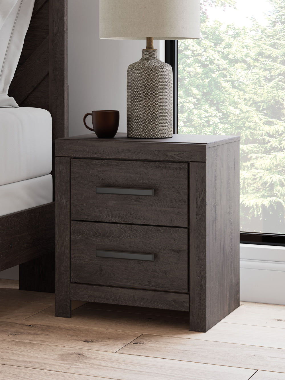 Designed with everyday style in mind, this nightstand is a simply chic approach to modern living. A dark charcoal finish blends black and brown undertones, creating a versatile look that effortlessly pairs with your existing pieces. And for must-have func