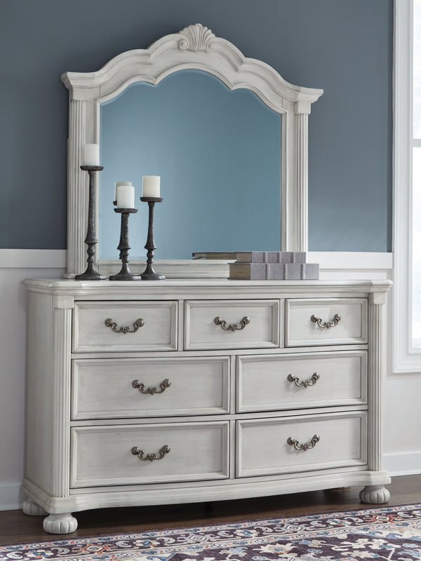  highlighted by a serpentine-shaped front with thick decorative moulding. Its dra