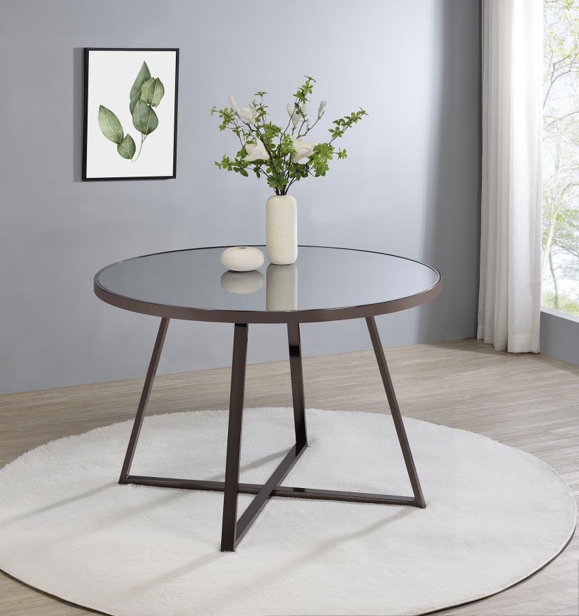 Gather for delicious meals with your favorite people in chic style with this contemporary dining table. The round table epitomizes modern minimalist design principles while adding decorative flair with subtle geometric touches in its angular, open frame s