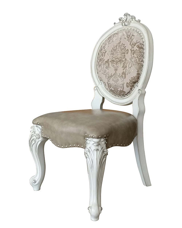 Irresistibly inviting, the Versailles collection displays the unrivaled beauty of the traditional dining. The dining table reflects highly decorative base with oversized scrolled feet, and the upholstered and tapestried chairs with deep button tufted and 
