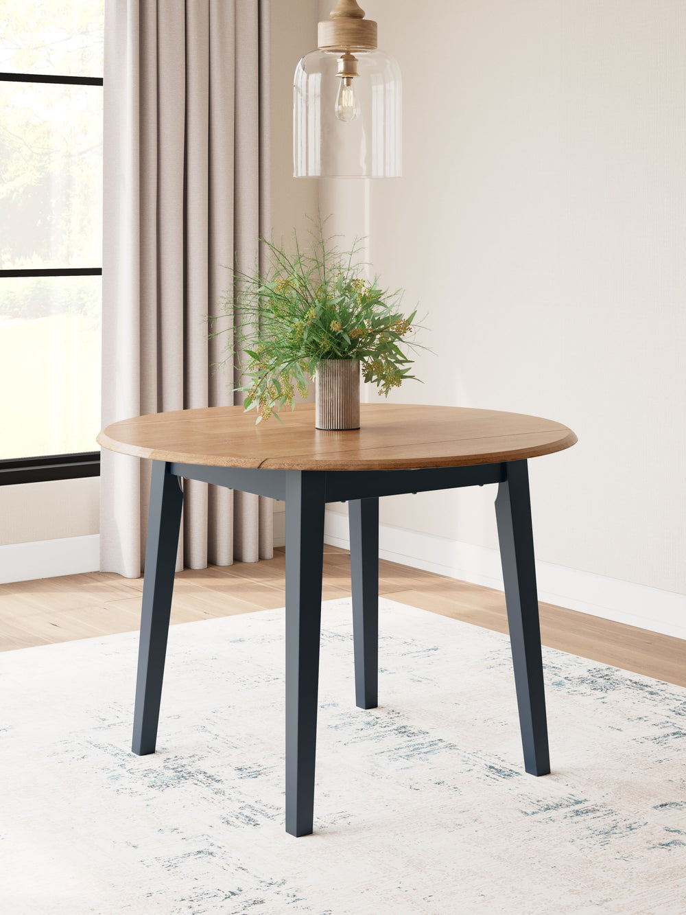 Complement your homeâ€™s simply relaxed sensibility with this drop-leaf dining table. A dark blue hue offers a chic contrast to the natural wood tone, for a casual look that vibes with a variety of aesthetics. When guests drop by, convert it from a space-