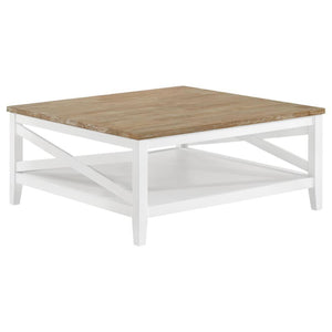 A square silhouette established a welcoming look and feel for a farmhouse coffee table. Great for family spaces, the cocktail table lends casual elegance with style that complements cottage, coastal and relaxed sitting areas. Its table top is wire brushed