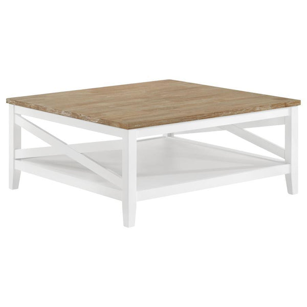 A square silhouette established a welcoming look and feel for a farmhouse coffee table. Great for family spaces, the cocktail table lends casual elegance with style that complements cottage, coastal and relaxed sitting areas. Its table top is wire brushed