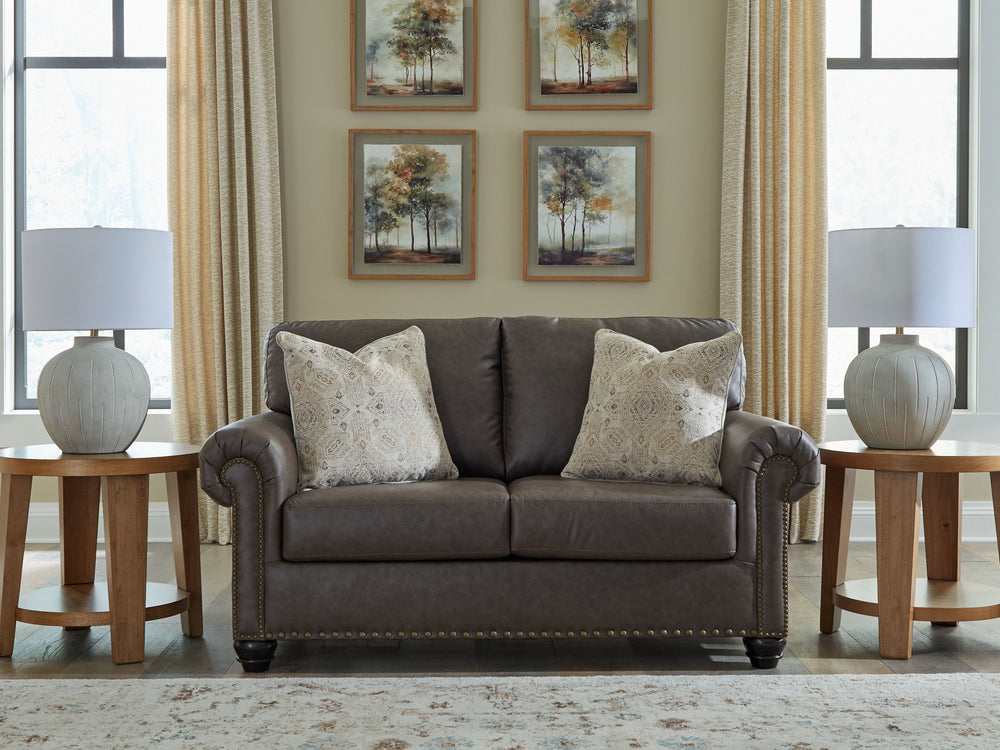 This loveseat marries classic character with a contemporary attitude. Love the timeless look of leather? Its take on deep brown faux leather is versatile enough to pair with styles from traditional to modern, at a price that wonâ€™t break the bank. Detail