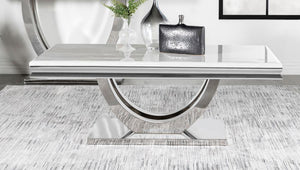  featuring a marble-like appearance and beveled edges. Its sweeping demilune pedestal base