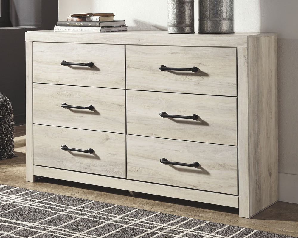 What a delightful take on rustic industrial style. Whether modern loft or modern farmhouse, this dresser makes itself at home. The wispy whitewash palette enhances without covering the grain for that weathered look you crave. Elongated drawer pulls elevat
