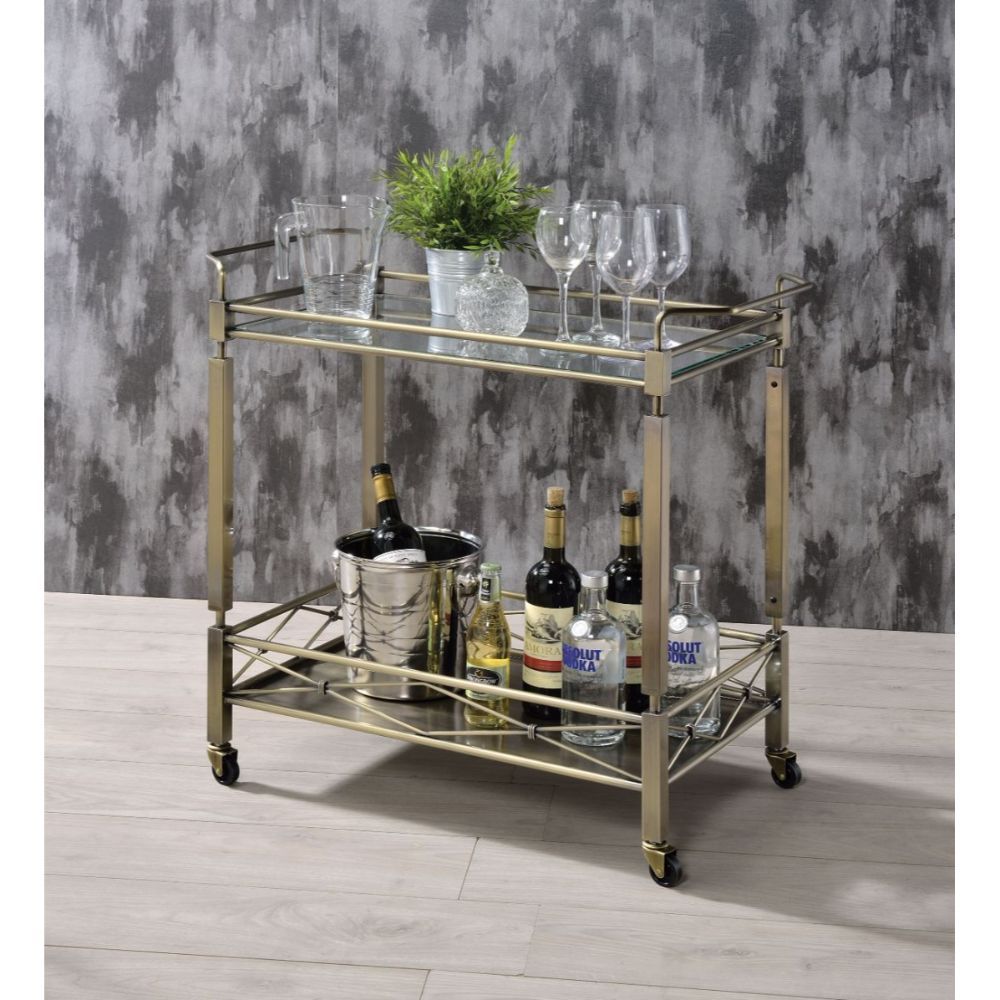 Add a touch of sophistication to your entertaining area with this Matiesen serving cart. With metal in antique brass finish, and clear tempered glass on the top shelf. The caster wheels allow you to move from room to room effortlessly. Simple and elegant,