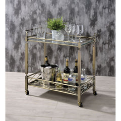 Add a touch of sophistication to your entertaining area with this Matiesen serving cart. With metal in antique brass finish, and clear tempered glass on the top shelf. The caster wheels allow you to move from room to room effortlessly. Simple and elegant,