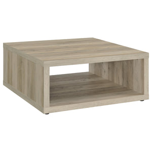 This coffee table combines rustic charm and modern simplicity, crafted from durable engineered wood with a dark pine wood-look finish. Its cube-inspired design features two open sides and a lower shelf for practical storage or display. The wood look lamin