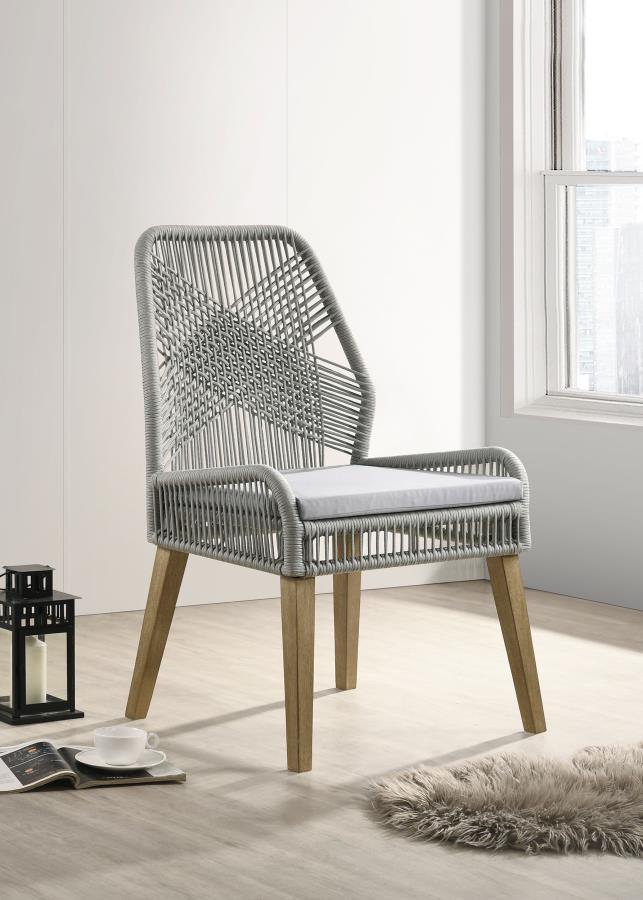 Capture the exotic flavor of this fun dining chair. Perfect for everyday use in a dressed up casual space, its sleek grey woven seat and seat back reflects an artful, inspirational design. Weathered wash finish wood legs taper slightly and slant just enou