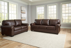 Sporting traditional elements including a roll arm frame with nailhead trim, this set provides here-and-now relevance. Mix in this combination of comfort and affordable luxury for a look youâ€™ll love for years to come. <h4><b>Colleton - Dark Brown - Sofa
