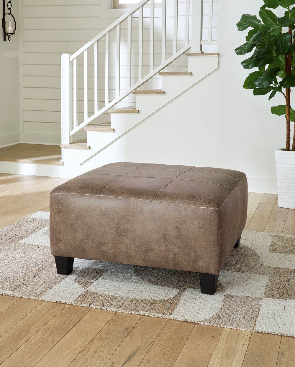 This decidedly modern oversized accent ottoman proves less is more, bringing simply inviting style to your living room. Take the guesswork out of decoratingâ€”its warm faux leather has a universal appeal, pairing with casual and contemporary aesthetics al