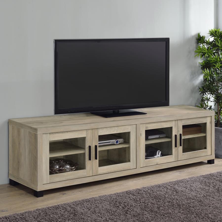 Upgrade your entertainment space with this 79-inch TV stand, featuring a contemporary boxy silhouette and smooth surfaces. The distressed pine finish enhances its rustic appeal, while the glass-paneled cabinet doors add a refined touch. Adjustable shelves
