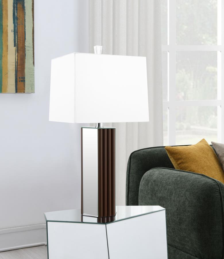 Establish a chic look and feel in your living room with a modern table lamp design. It-'s a rich, warm choice, featuring a deep brown finish and scallop details that create a sense of texture and artisan character. Mirror panels add brightness and reflect