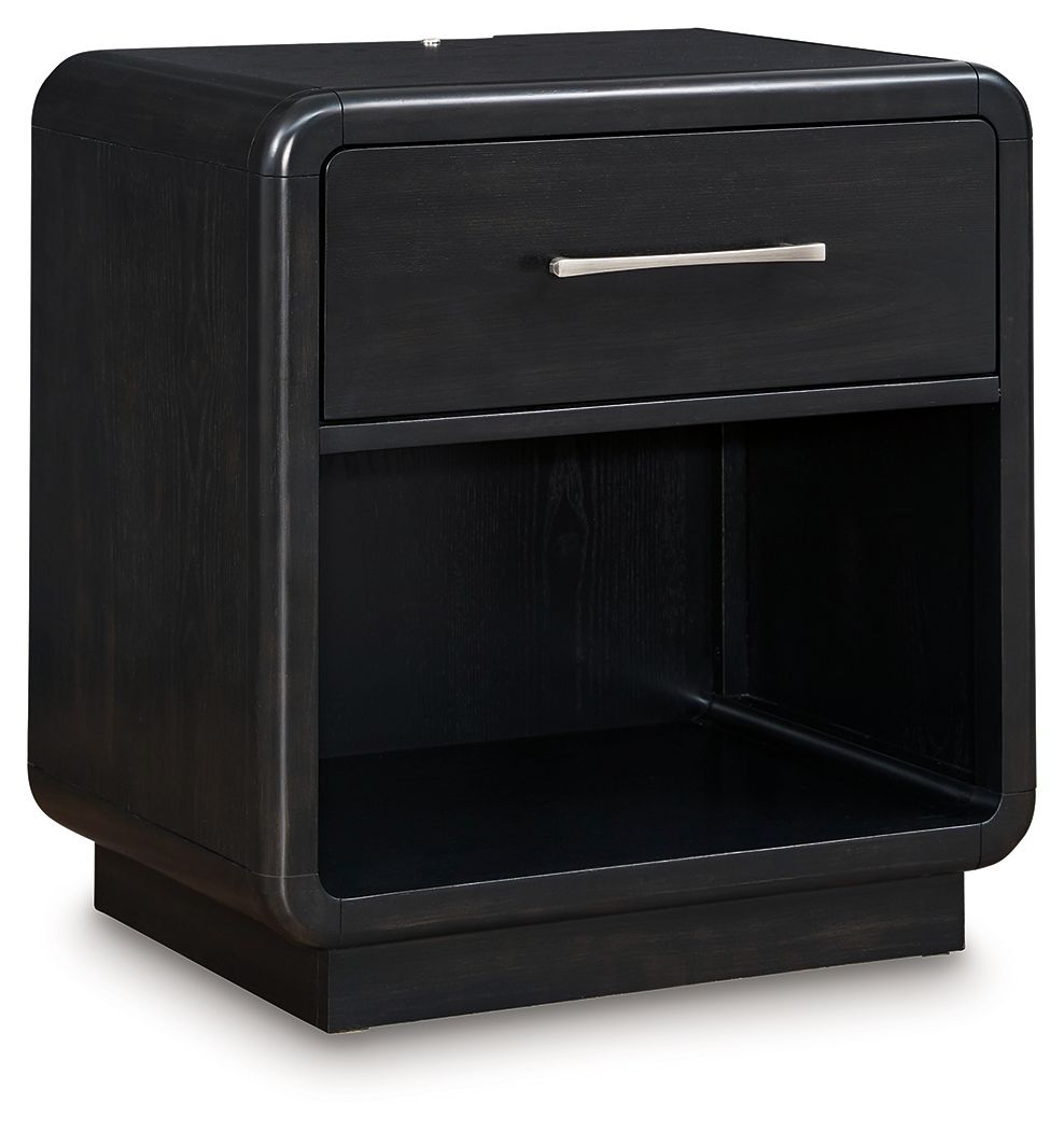 Inspired by art deco design, this softly shaped nightstand makes a lasting impression in a simply stunning way. Its magnificent curved silhouette is enhanced by a rich layered black finish on the textured wood grain surface. Complete with an LED nightligh