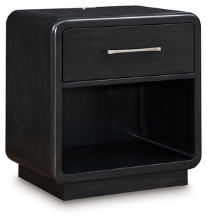 Inspired by art deco design, this softly shaped nightstand makes a lasting impression in a simply stunning way. Its magnificent curved silhouette is enhanced by a rich layered black finish on the textured wood grain surface. Complete with an LED nightligh