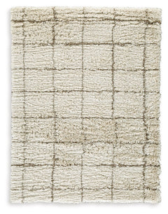 When is a rug more than a rug? When it invites you to kick off your shoes and stay a while. This shag rug welcomes visitors with warmth and a tantalizingly thick, plush pile. Its neutral color palette exudes a casually cool vibe that works wonders whereve