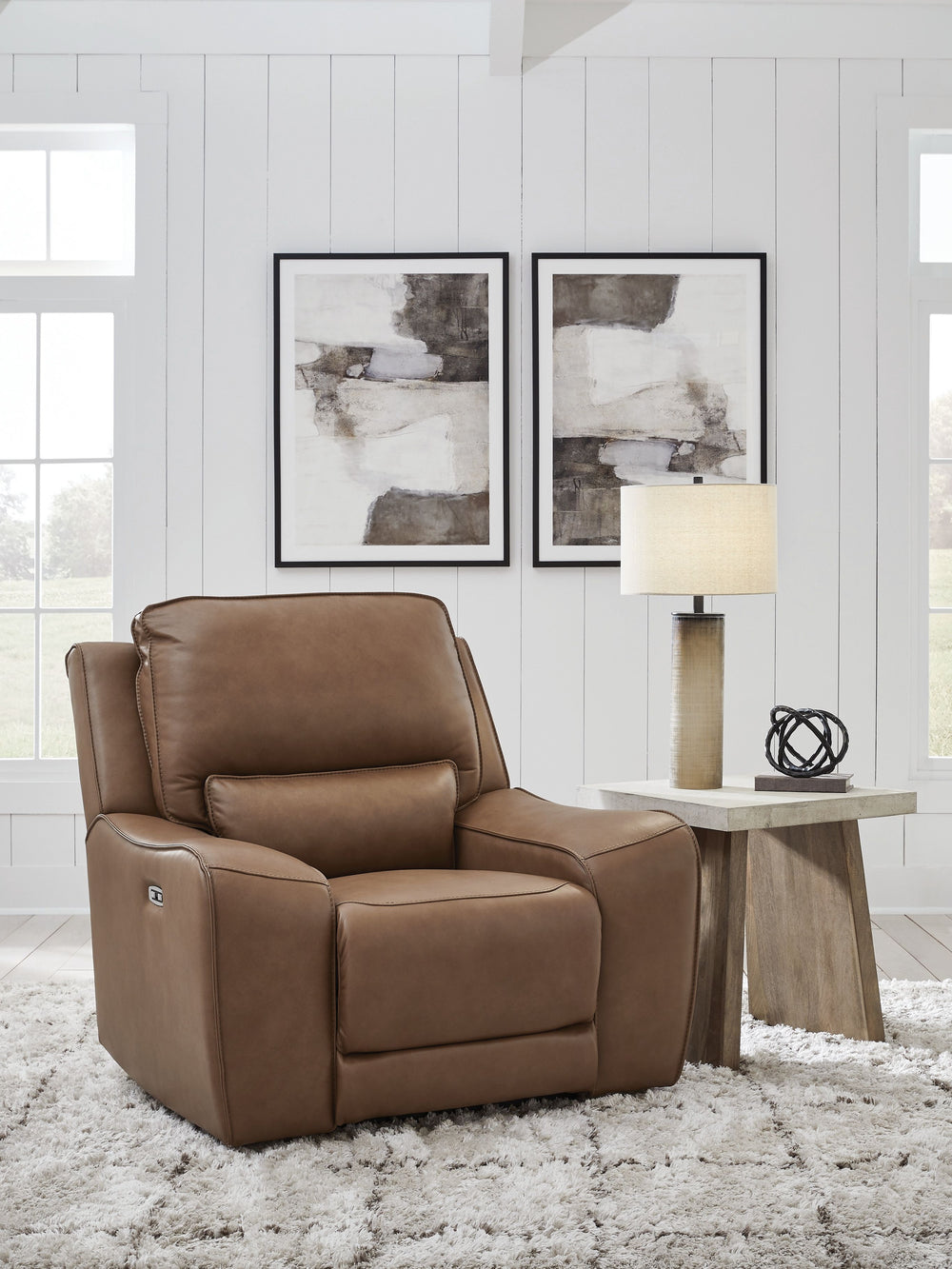 Live and lounge luxuriously. This power recliner brings an ultra-stylish flair to your homeâ€™s central hub. Its seating area is wrapped in top-grain leather in a rich caramel coloration, giving you a trend-right look made all the better with high-quality