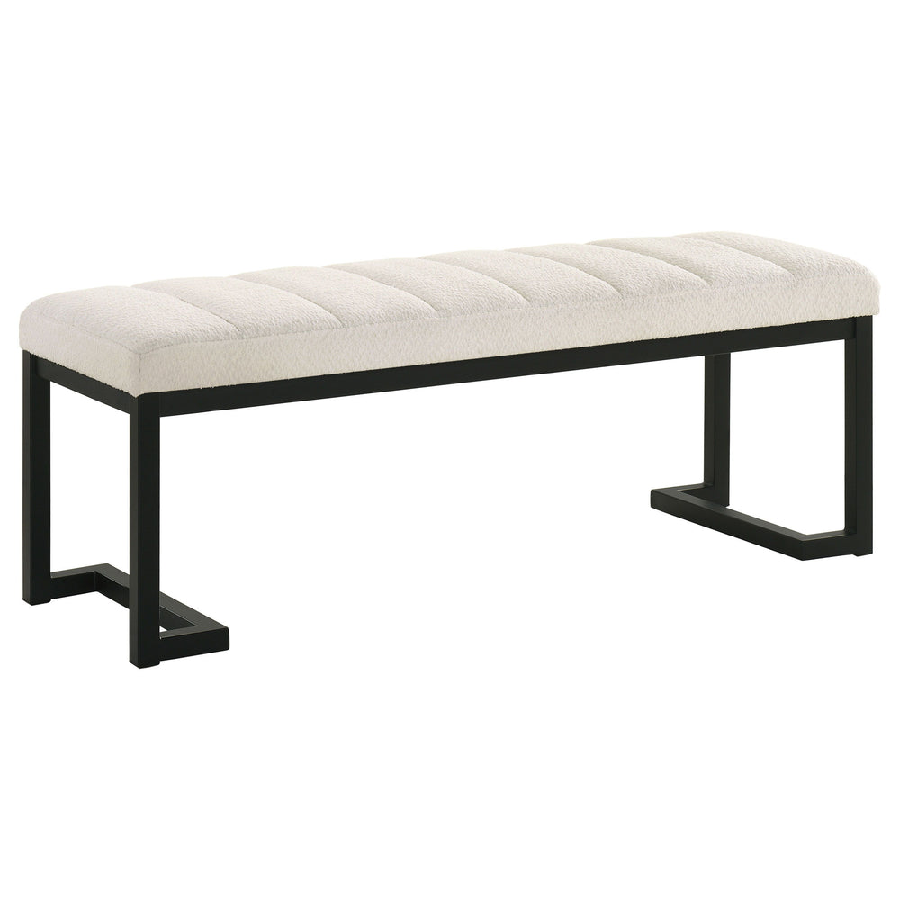 Textured upholstery play perfectly with the modern silhouette of a backless accent bench. Its deep black finished frame is constructed in metal for excellent durability, with a bracket inspired silhouette that emphasizes its contemporary design credential