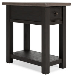 Quality crafted and richly styled, this rectangular chairside end table is sure to charm. Its two-tone aesthetic pairs a weathered grayish brown tabletop with a textured wire brushed base in black. A built-in shelf offers handy display space. And the tabl