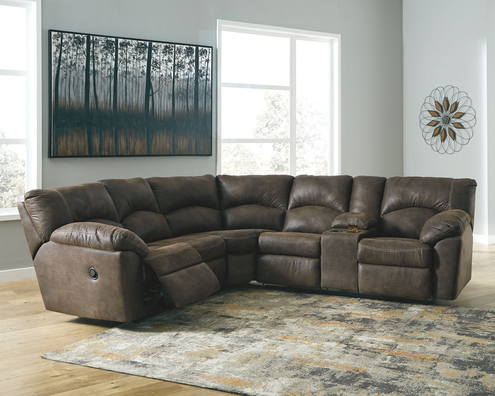 With plush cushions and wraparound pillow top arms, this sectional takes comfort to a whole new level. Faux vintage leather requires minimal care, making this relaxation station ideal in homes with children and pets. Reclining feature engages with the pul
